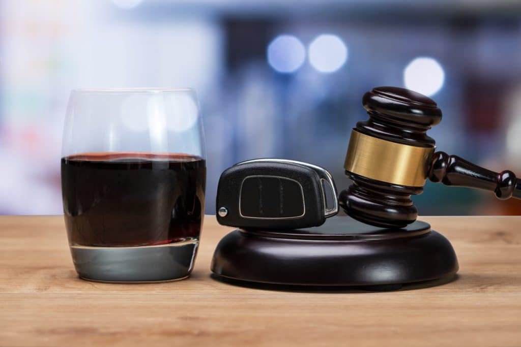 Car Key And Gavel Near Glass Of Alcohol