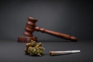 New Law - Legalize Marijuana. Wooden judge hammer. Cannabis legalization as medical drug. CBD healing social issue concept. Legality of cannabis, legal and illegal cannabis.